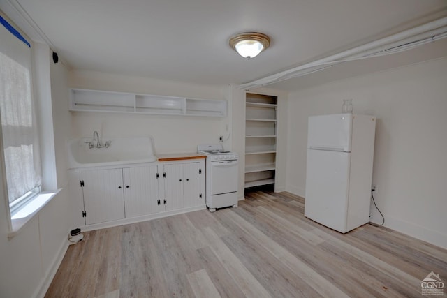 laundry room featuring light wood-type flooring and sink