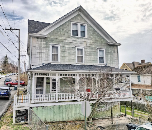 rear view of property featuring a porch