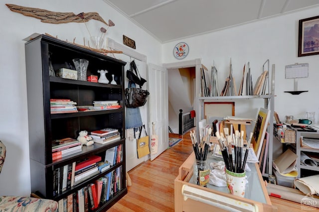 home office featuring crown molding and hardwood / wood-style flooring