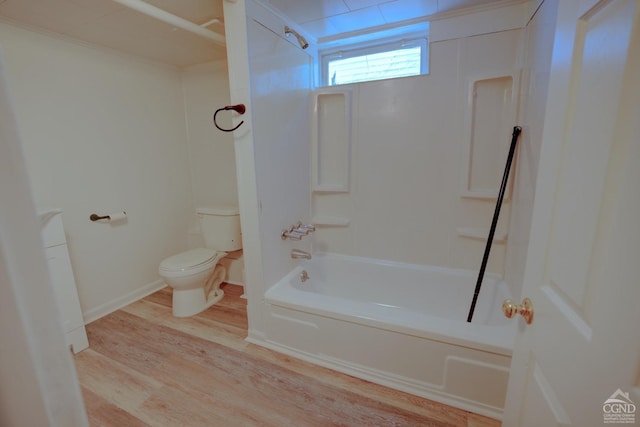 bathroom featuring wood-type flooring, shower / bath combination, and toilet