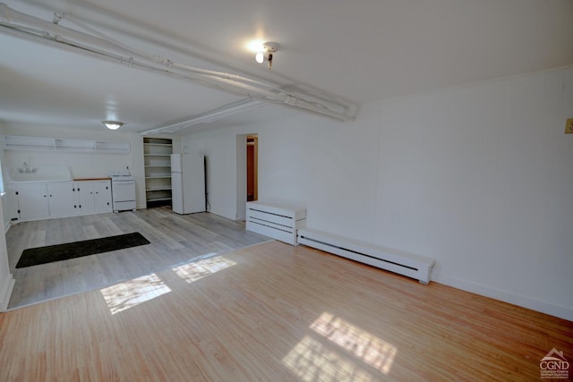 interior space featuring light hardwood / wood-style flooring and a baseboard heating unit