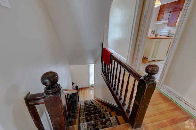 stairs featuring wood-type flooring