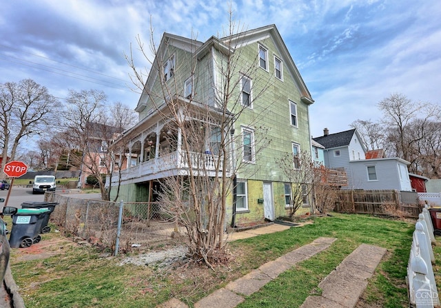 rear view of property with a lawn