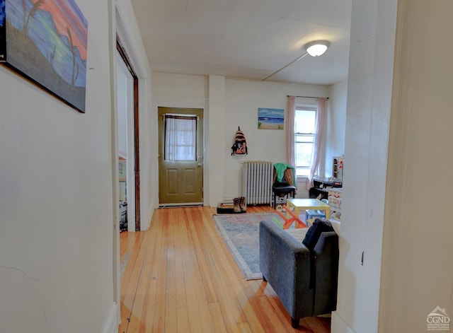 foyer with wood-type flooring and radiator