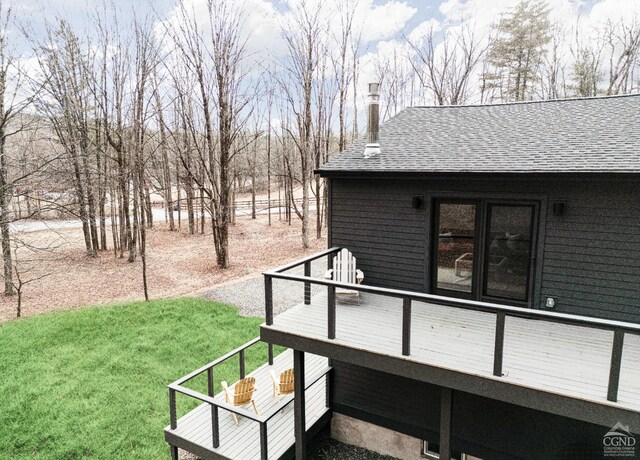 wooden terrace featuring a yard