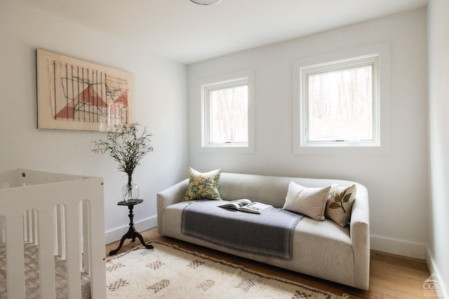 living area featuring baseboards and wood finished floors
