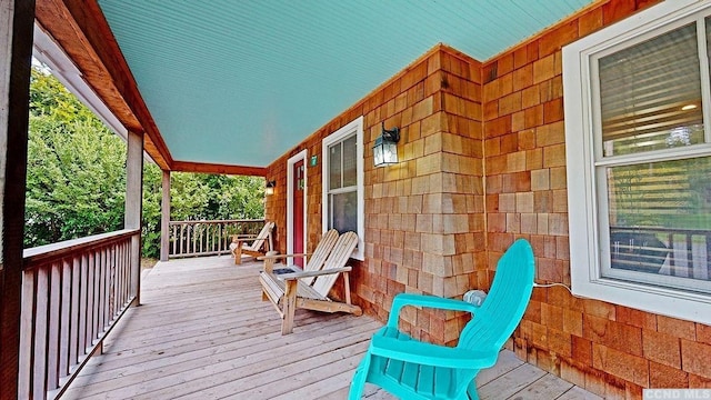 wooden terrace featuring covered porch