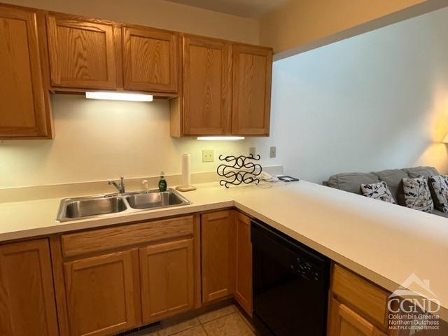 kitchen with dishwasher, light tile patterned flooring, and sink