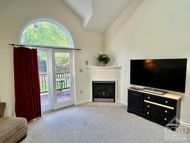 living room featuring high vaulted ceiling and light colored carpet