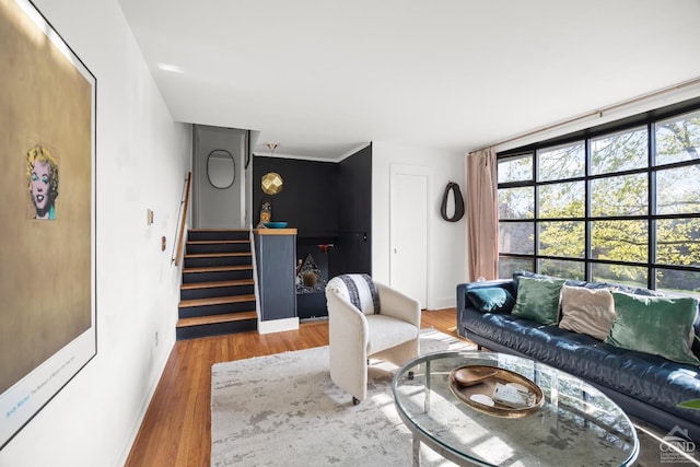 living room with baseboards, stairway, and wood finished floors
