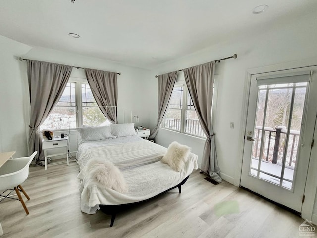 bedroom featuring access to outside and light hardwood / wood-style floors