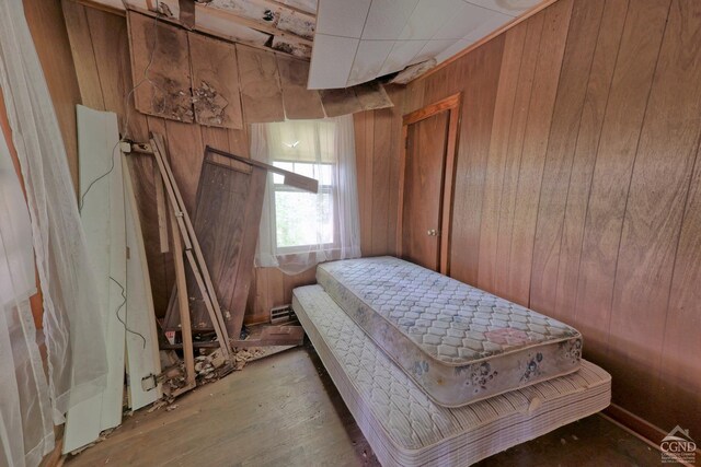 bedroom with wooden walls