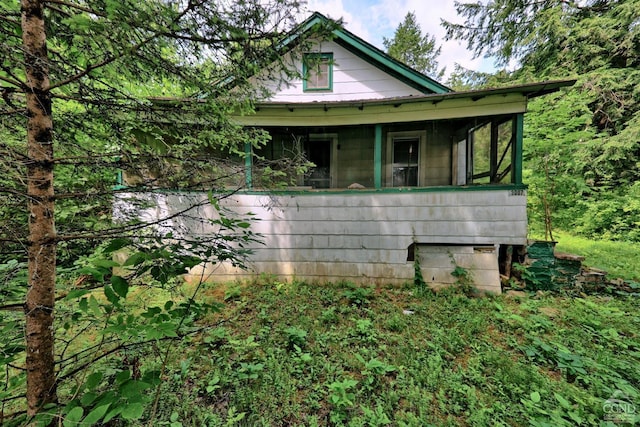 view of property exterior with a sunroom