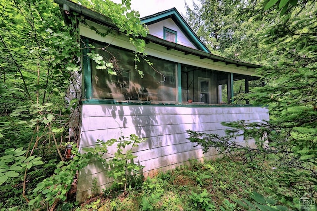 view of home's exterior featuring a sunroom