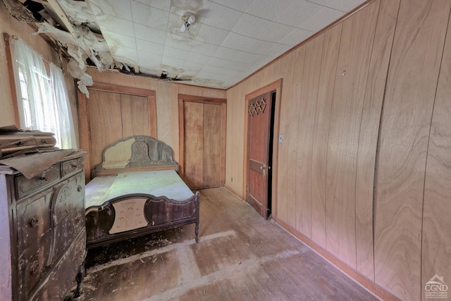 bedroom featuring wood walls