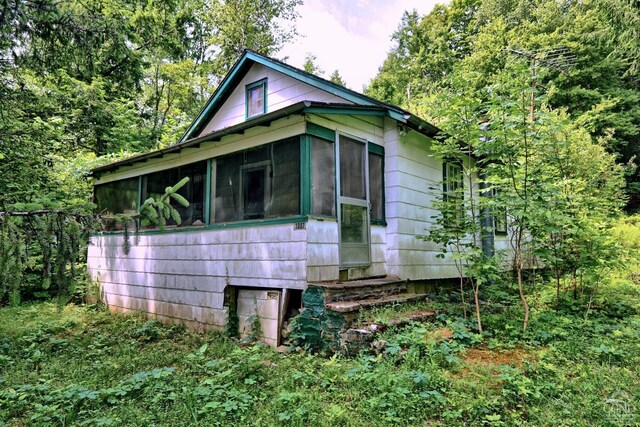 view of side of property with a sunroom