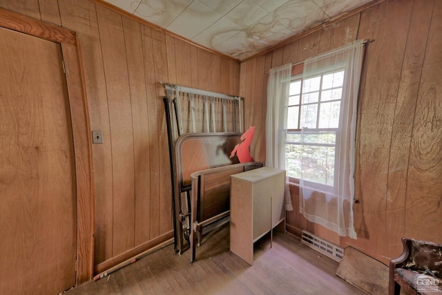 miscellaneous room featuring hardwood / wood-style flooring and wooden walls