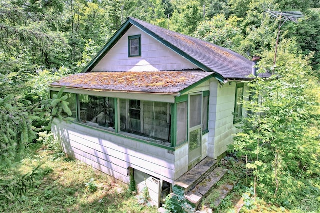 view of side of property with a sunroom