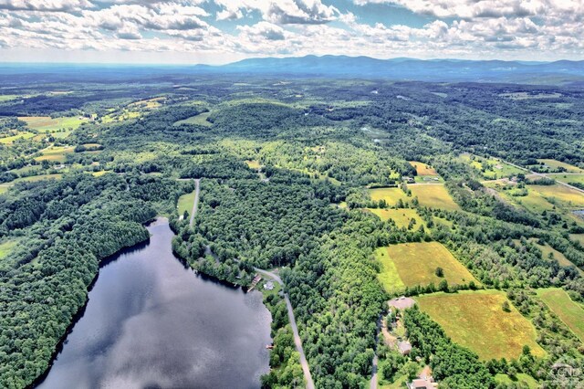 drone / aerial view featuring a water and mountain view