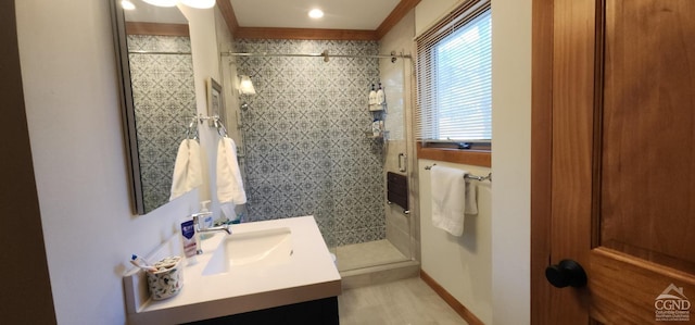 full bath featuring vanity and tiled shower