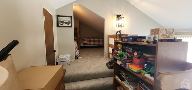 carpeted bedroom with lofted ceiling