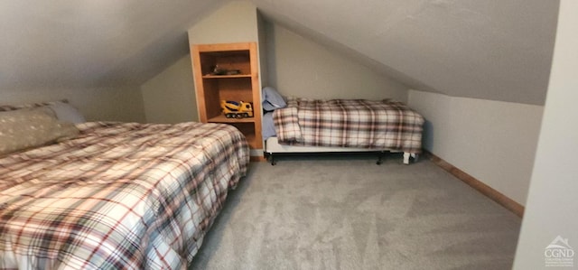 carpeted bedroom with lofted ceiling and baseboards