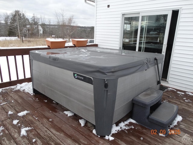 wooden deck featuring a hot tub