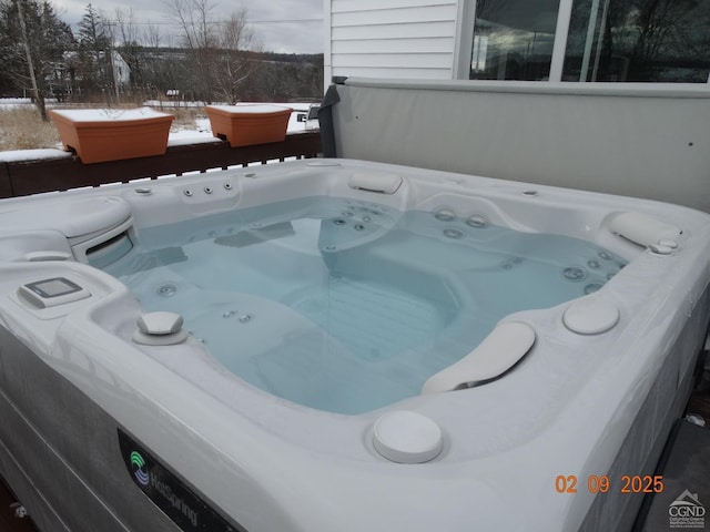 exterior space with a hot tub and washer / dryer