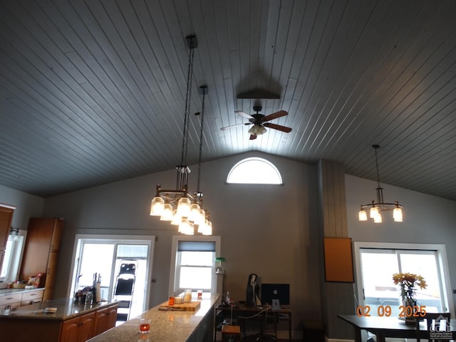 dining space featuring a chandelier and vaulted ceiling