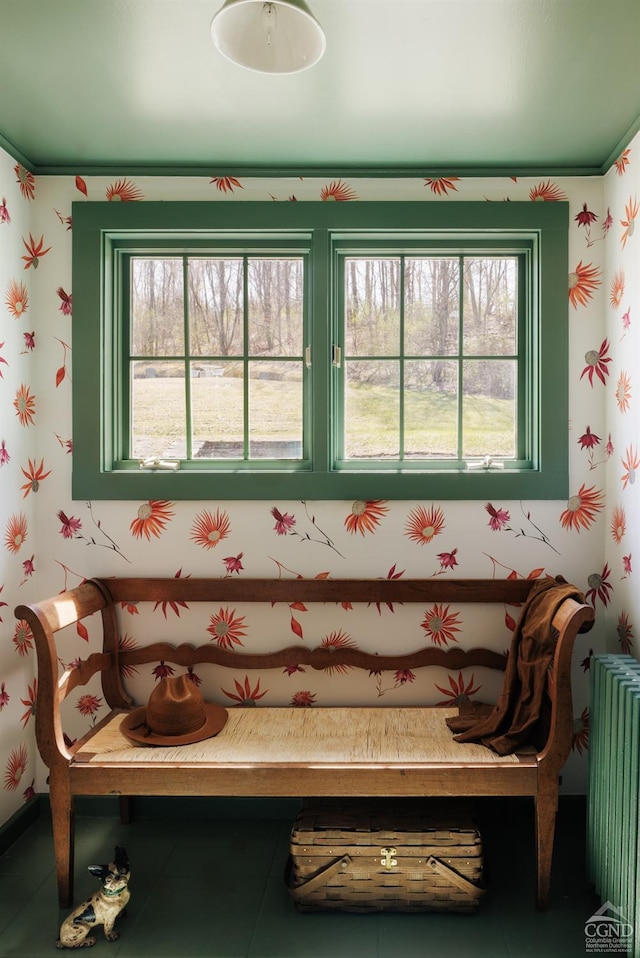 living area featuring radiator heating unit, tile patterned flooring, and wallpapered walls
