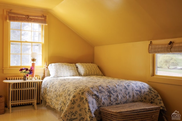 bedroom with lofted ceiling and radiator