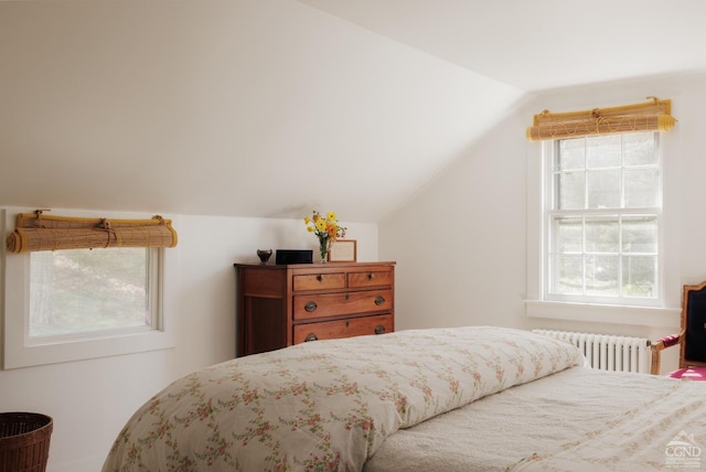bedroom with radiator heating unit and vaulted ceiling