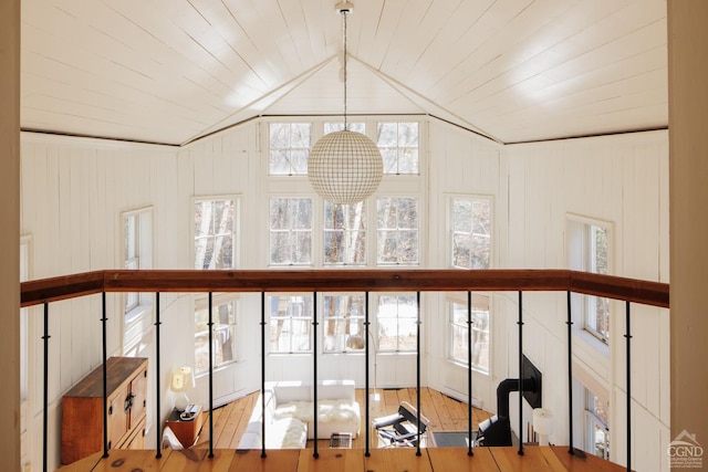 room details featuring wooden ceiling, wooden walls, and wood-type flooring