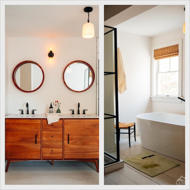 bathroom featuring hardwood / wood-style flooring, a washtub, and vanity