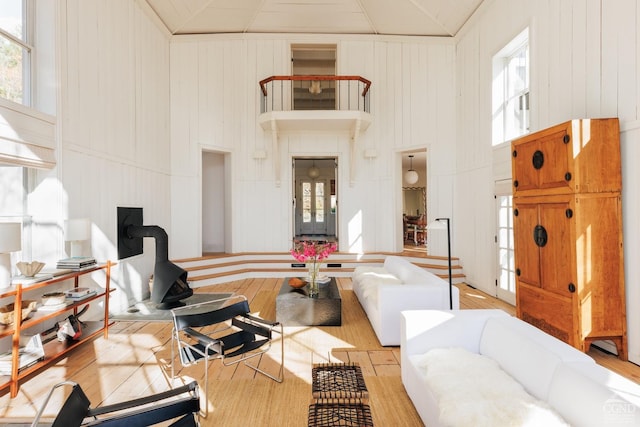 living area with high vaulted ceiling and wood finished floors