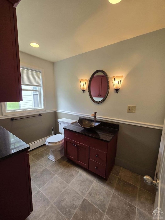 bathroom with vanity, a baseboard radiator, and toilet