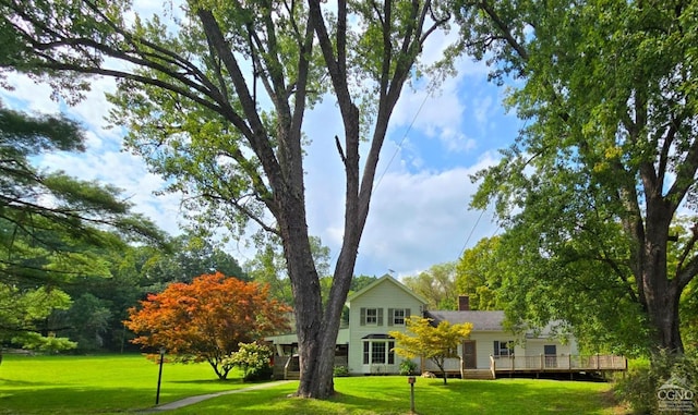 view of front of home featuring a front yard and a deck