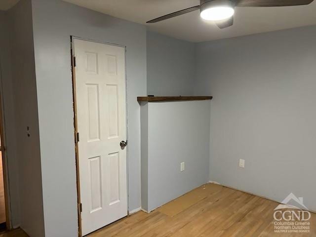 empty room with light hardwood / wood-style floors and ceiling fan