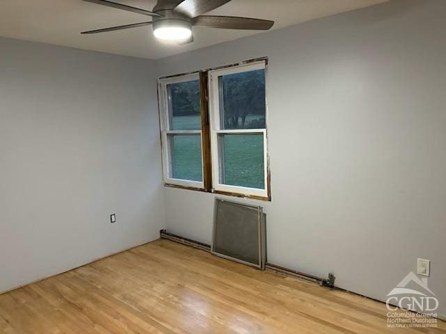 unfurnished room with ceiling fan and light wood-type flooring