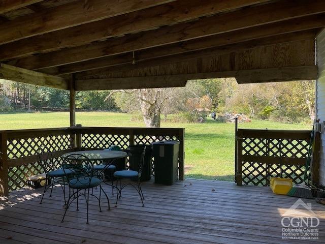 wooden terrace with a yard