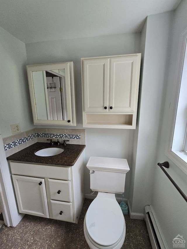 bathroom featuring vanity, toilet, decorative backsplash, and baseboard heating