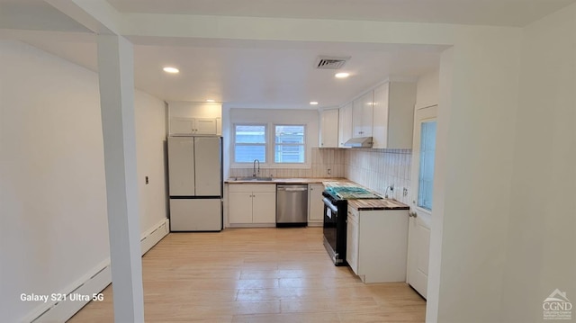 kitchen with black range with electric cooktop, a baseboard heating unit, visible vents, freestanding refrigerator, and dishwasher