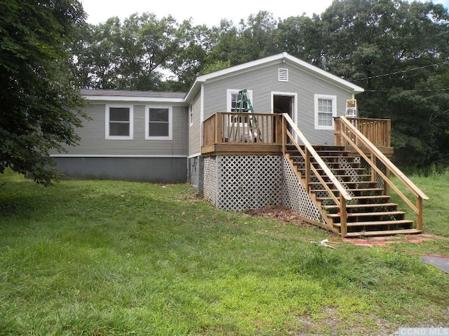 back of house with a yard and a wooden deck