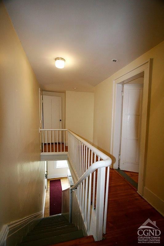 staircase with wood-type flooring