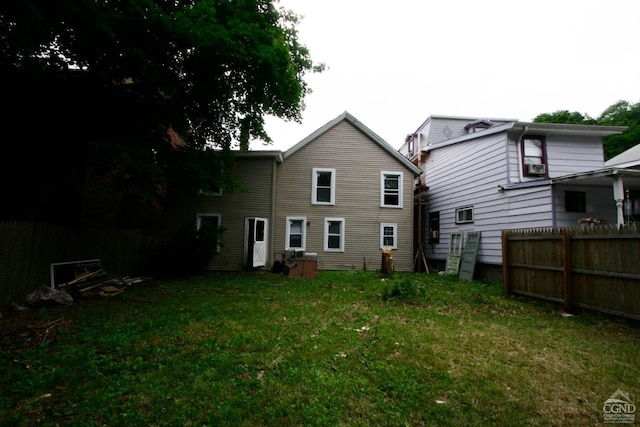 rear view of property featuring a yard