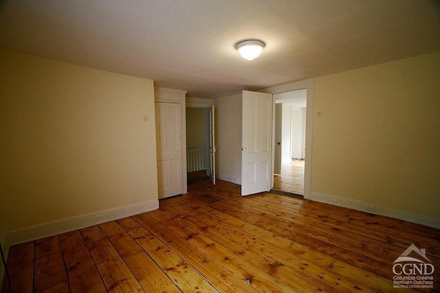 unfurnished bedroom with hardwood / wood-style floors