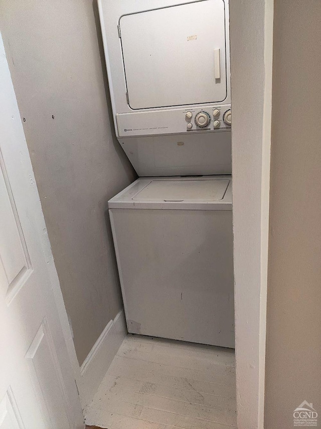 laundry room featuring stacked washer and clothes dryer