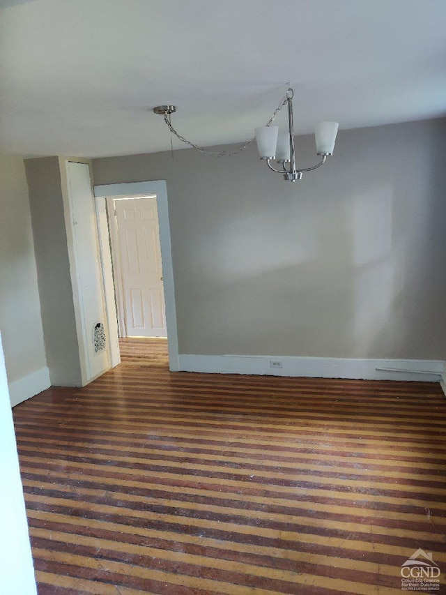 unfurnished room with an inviting chandelier