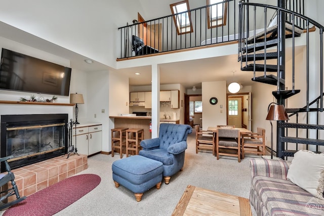 living room featuring a high ceiling and light colored carpet