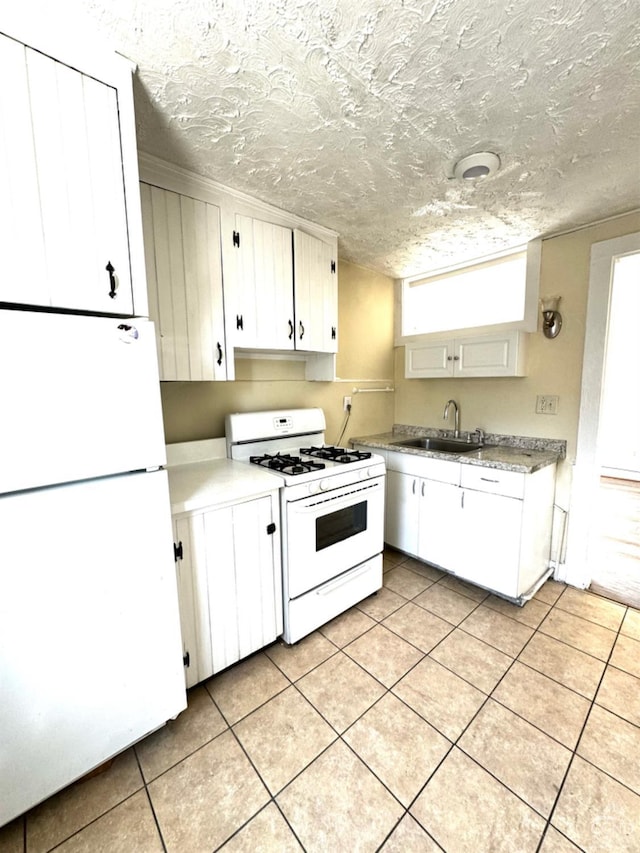 kitchen with a textured ceiling, white cabinetry, sink, and white appliances